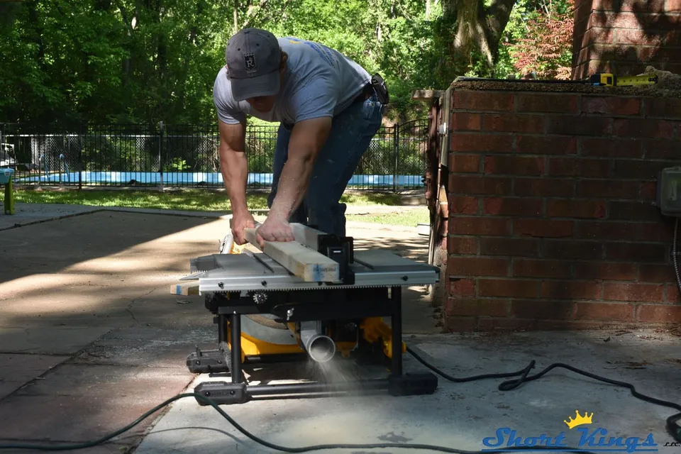 Cutting wood for door trim with a table saw on a patio